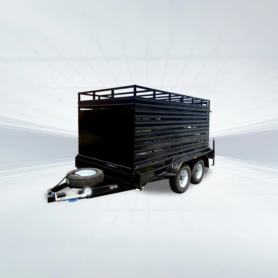 Studio side angled view of black stock crate trailer with mesh sides and spare wheel on white background.