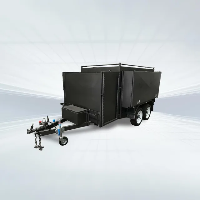 Studio side angled view of black 8x5 lawn mowing tipper trailer with barn doors on white background.