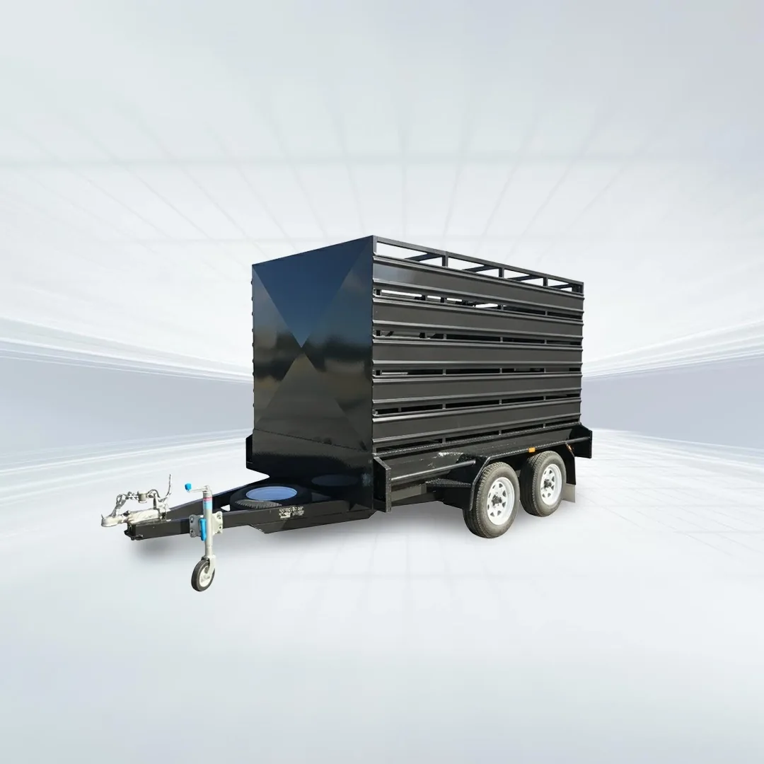 Studio side angled view of black stock crate trailer with solid front panel and mesh sides on white background.