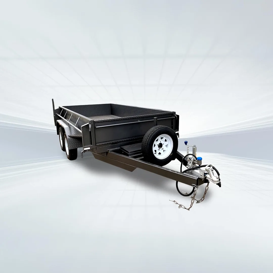 Studio side angled view of black 8x5 tipper trailer with machinery upgrade and slide-in ramps on white background.