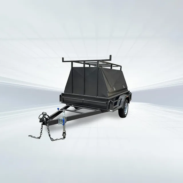 Studio side angled view of black 8x5 tradesman trailer with two-piece canopy and roof rack on white background.